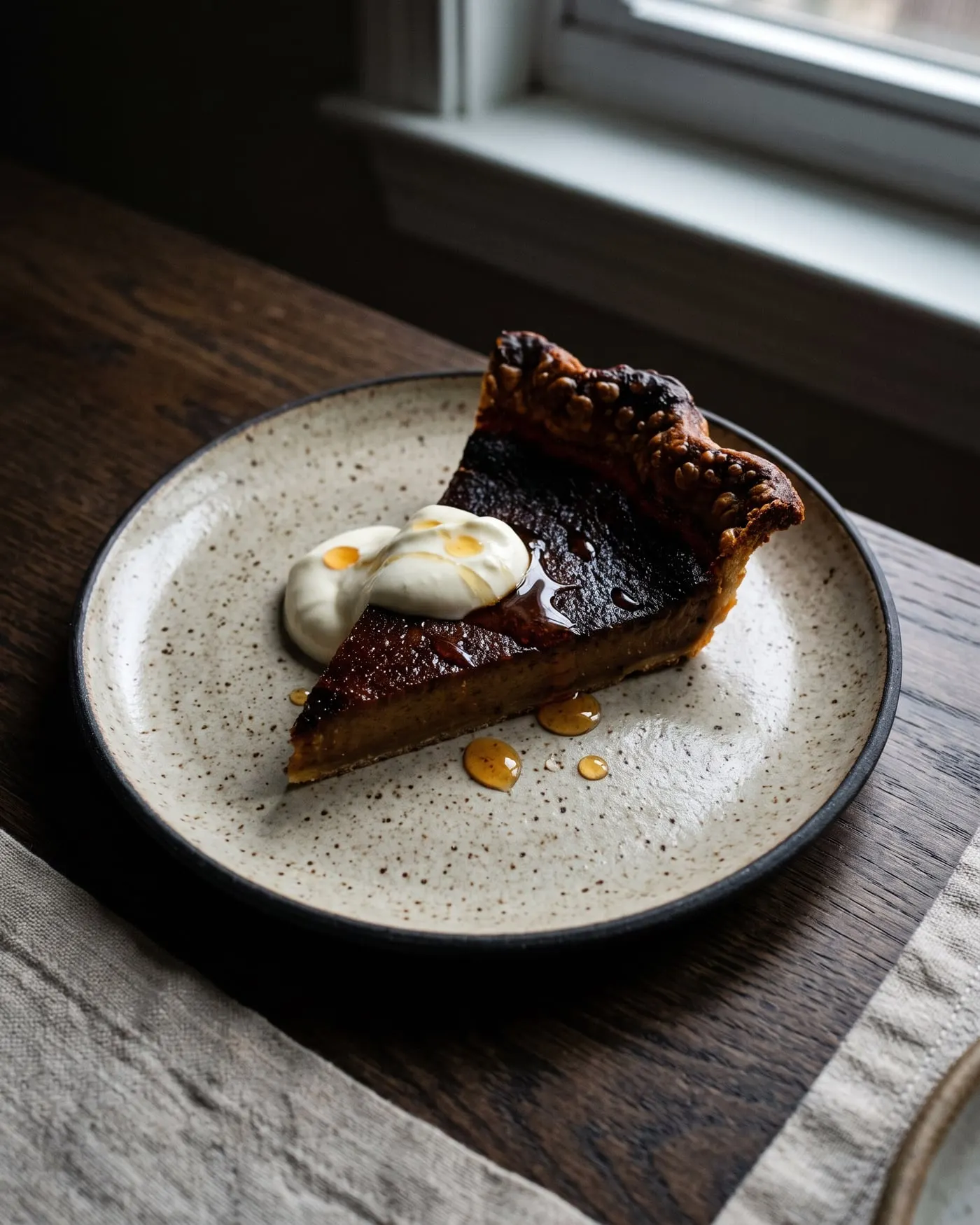 A slice of burnt honey tart with crème fraîche