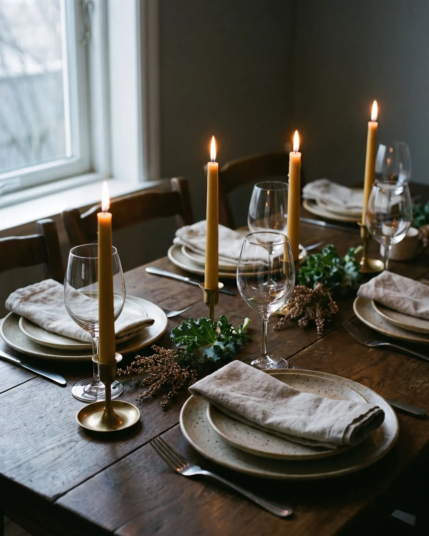 Candles, glasses and stoneware along the private dining table